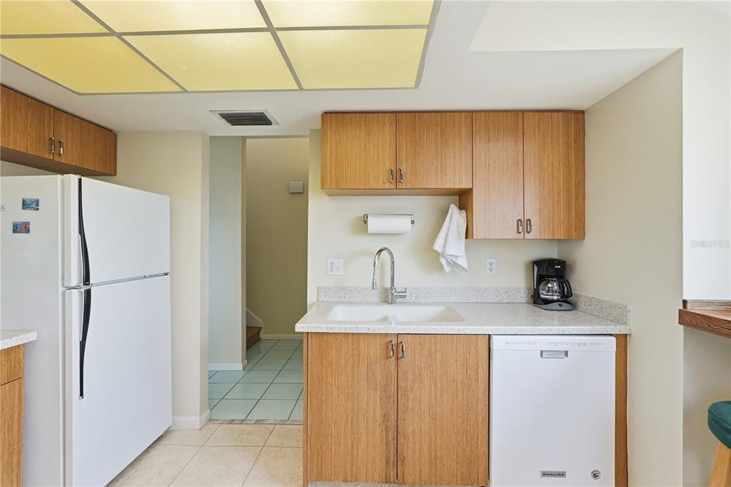 1500 Sunset Road, Unit C10 Tarpon Springs, FL 34689 - Photo 11 of 27 a kitchen with a refrigerator sink and cabinets
