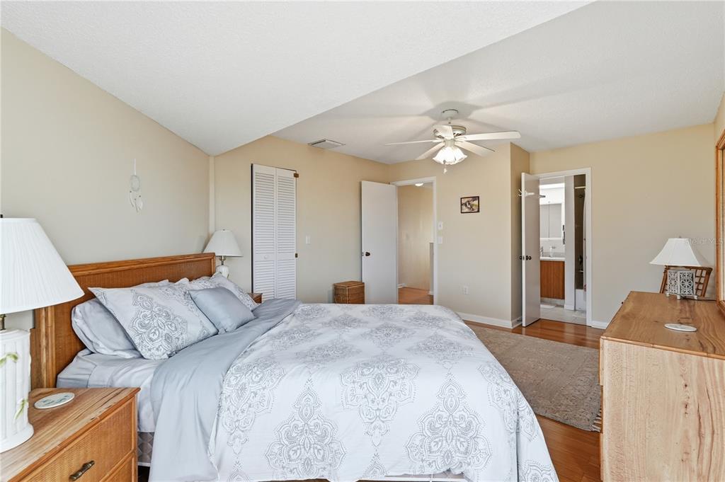 1500 Sunset Road, Unit C10 Tarpon Springs, FL 34689 - Photo 17 of 27 a spacious bedroom with a bed and a chandelier