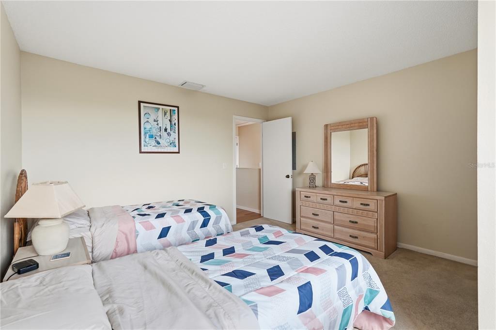 1500 Sunset Road, Unit C10 Tarpon Springs, FL 34689 - Photo 19 of 27 a bedroom with a bed and a dresser