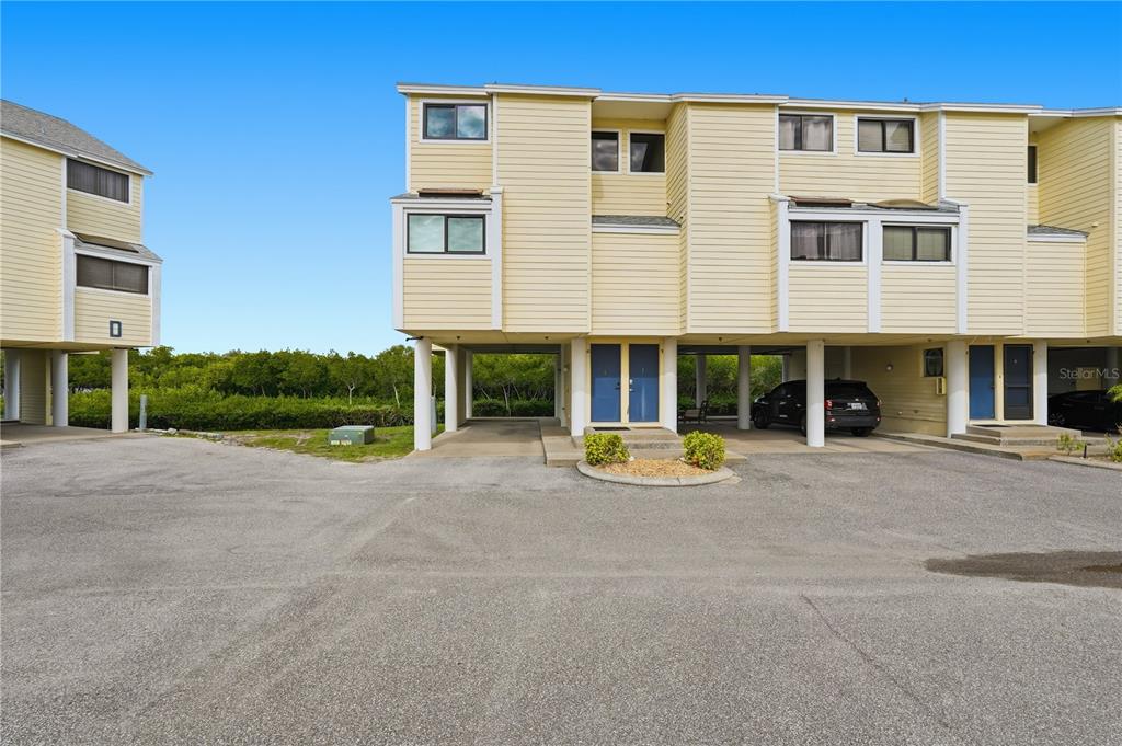 1500 Sunset Road, Unit C10 Tarpon Springs, FL 34689 - Photo 2 of 27 a view of a building with a patio and a yard