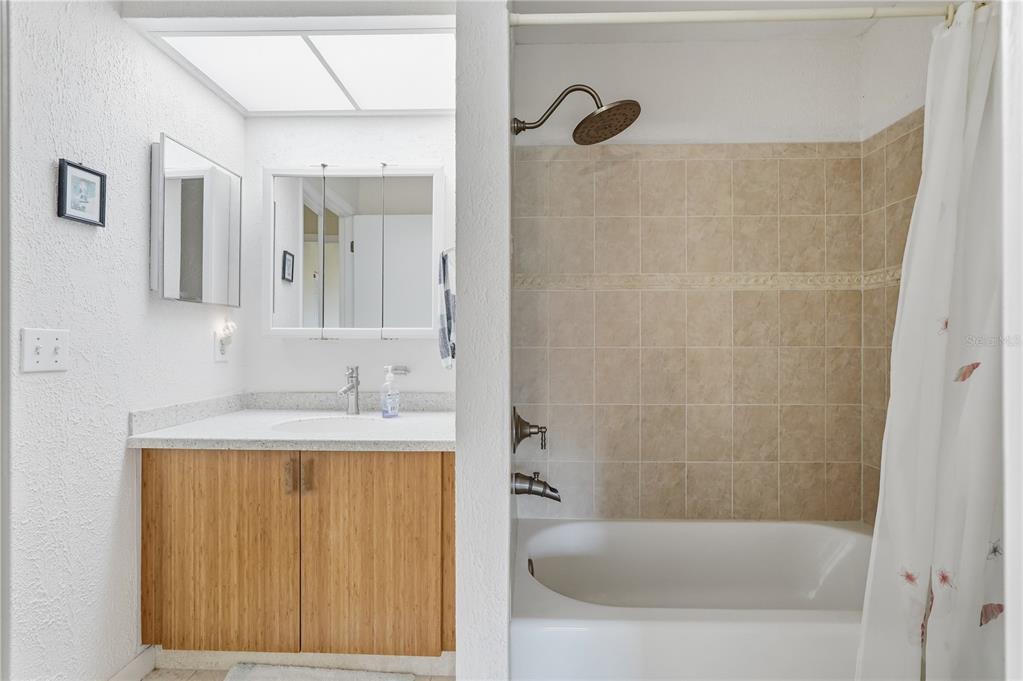 1500 Sunset Road, Unit C10 Tarpon Springs, FL 34689 - Photo 21 of 27 a bathroom with a granite countertop sink a mirror and a bathtub