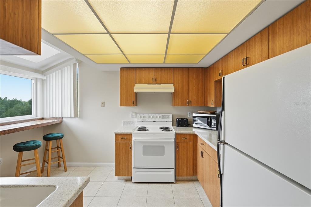 1500 Sunset Road, Unit C10 Tarpon Springs, FL 34689 - Photo 7 of 27 a kitchen with a stove top oven sink and cabinets