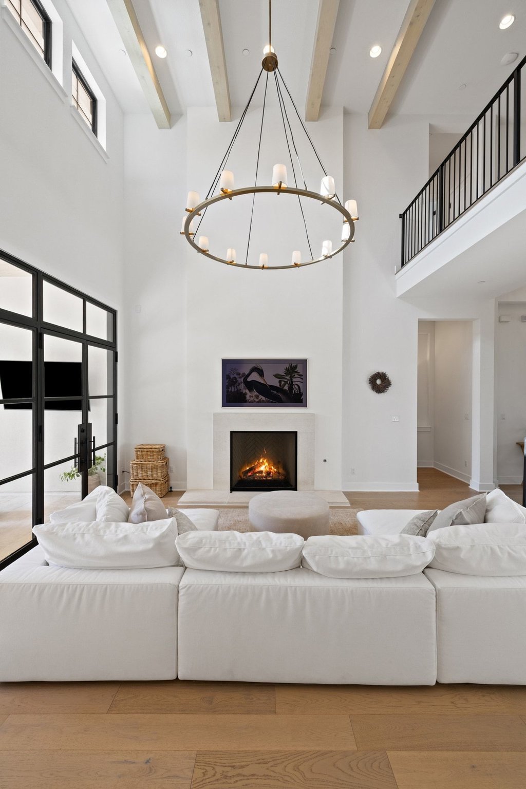 7516 Davenport Divide Road Austin, TX 78738 - Photo 13 of 40 The striking limestone fireplace is set against a Venetian plaster backdrop, creating an undeniable focal point in the towering living room.