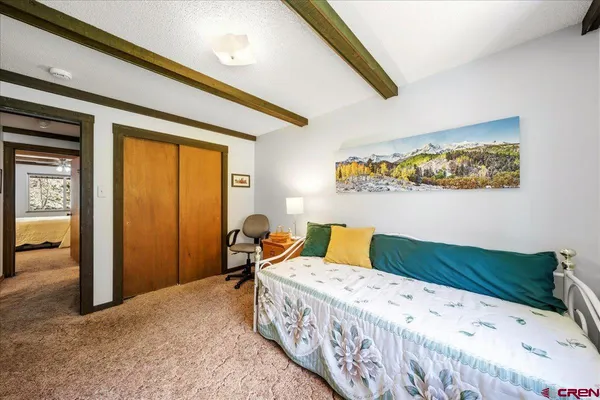 a bedroom with a large bed and a window