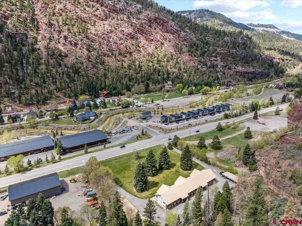 an aerial view of residential houses with outdoor space