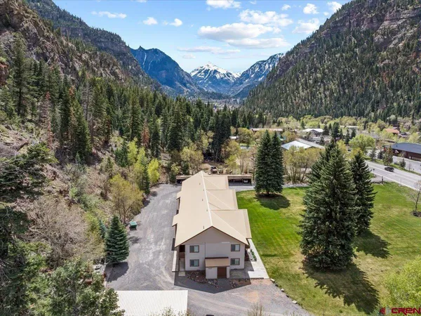 a aerial view of a house with a yard and lake view
