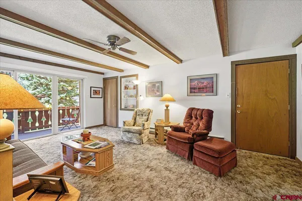 a living room with furniture and a floor to ceiling window