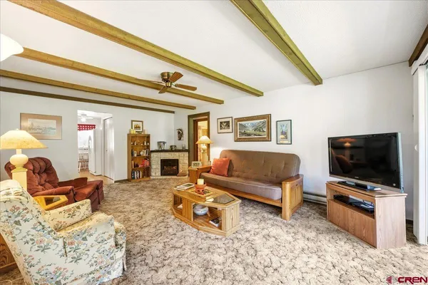 a living room with furniture and a flat screen tv