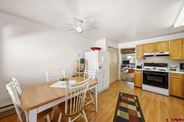 a view of a dining room with furniture and wooden floor