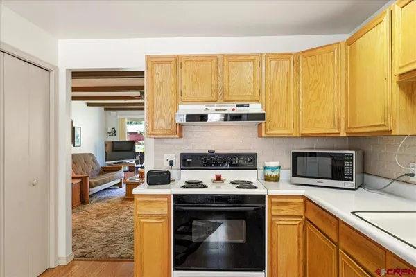 a kitchen with a stove a sink and cabinets