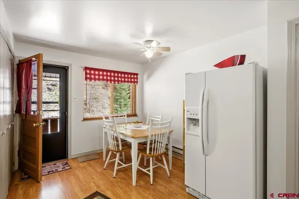 a view of a dining room with furniture window and wooden floor