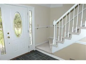 a bathroom with a granite countertop sink a toilet and shower