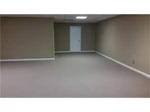 a kitchen with granite countertop a refrigerator a sink and wooden floor