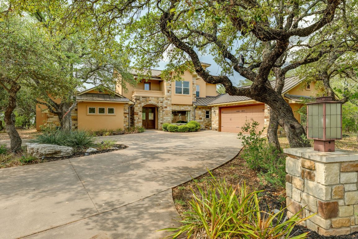 600 Mountain Dew Road Horseshoe Bay, TX 78657 - Photo 1 of 38 a front view of a house with a garden