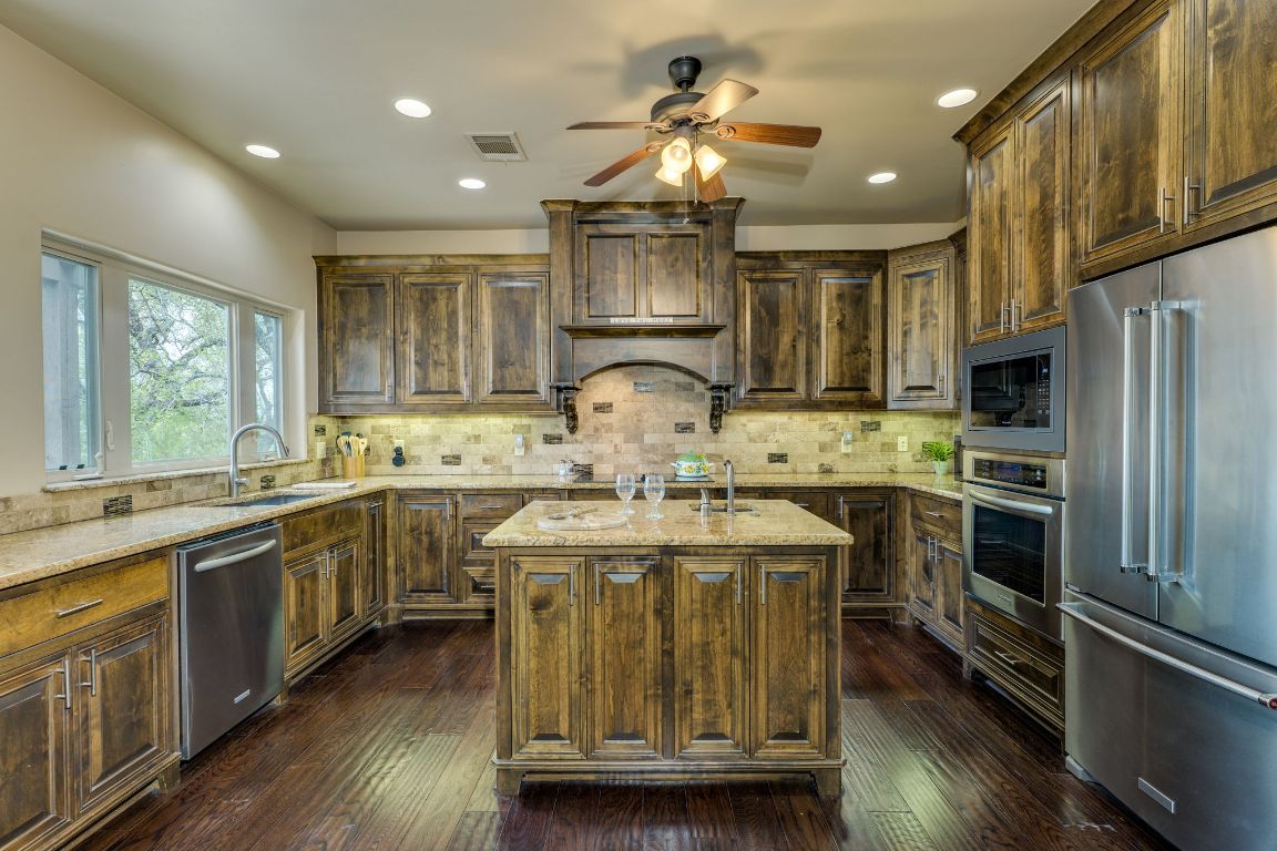 600 Mountain Dew Road Horseshoe Bay, TX 78657 - Photo 13 of 38 a kitchen with kitchen island granite countertop a sink appliances cabinets and furniture