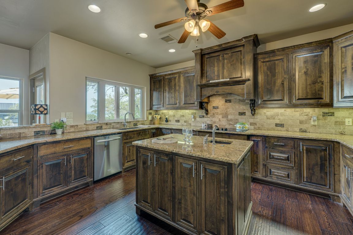 600 Mountain Dew Road Horseshoe Bay, TX 78657 - Photo 14 of 38 a kitchen with a sink stove and cabinets