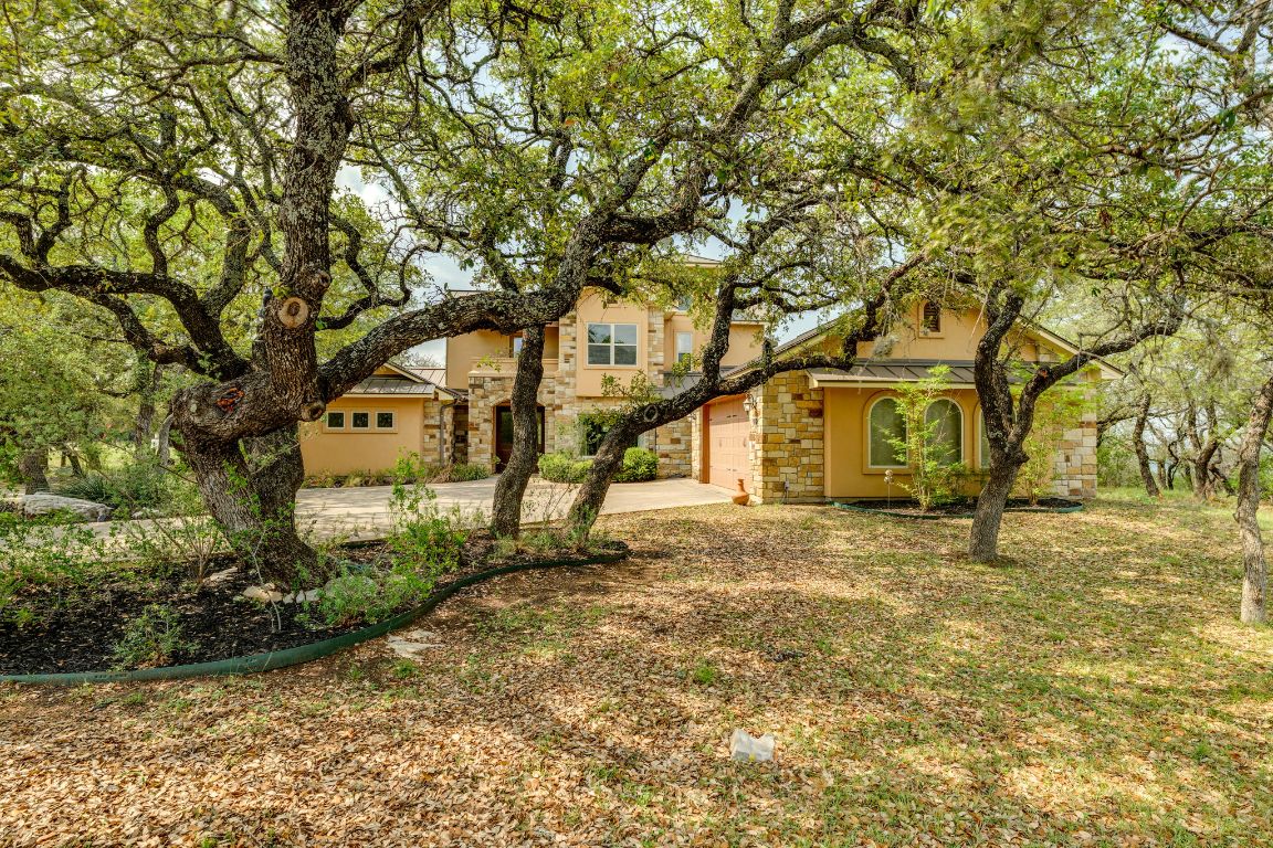 600 Mountain Dew Road Horseshoe Bay, TX 78657 - Photo 2 of 38 a tree in front of a white house