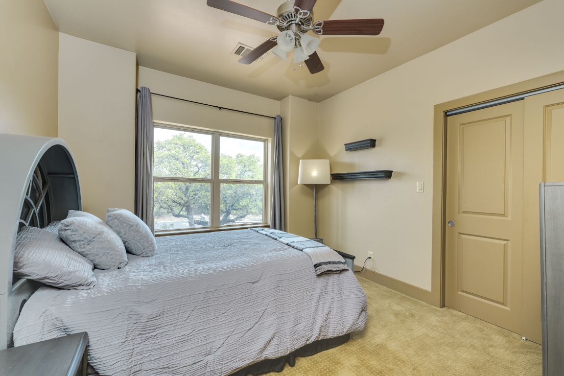 600 Mountain Dew Road Horseshoe Bay, TX 78657 - Photo 28 of 38 a bedroom with a bed and window
