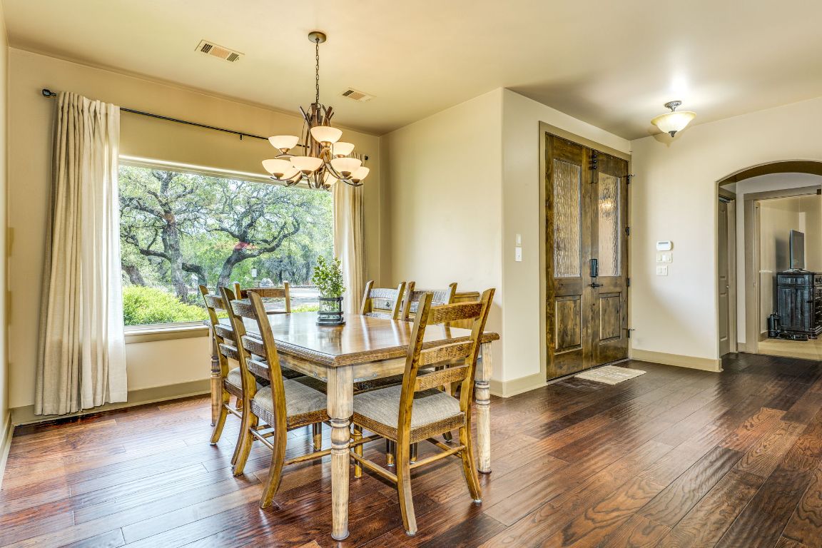 600 Mountain Dew Road Horseshoe Bay, TX 78657 - Photo 8 of 38 a view of a dining room with furniture window and wooden floor