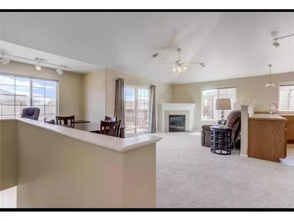 a view of living room with furniture and fireplace