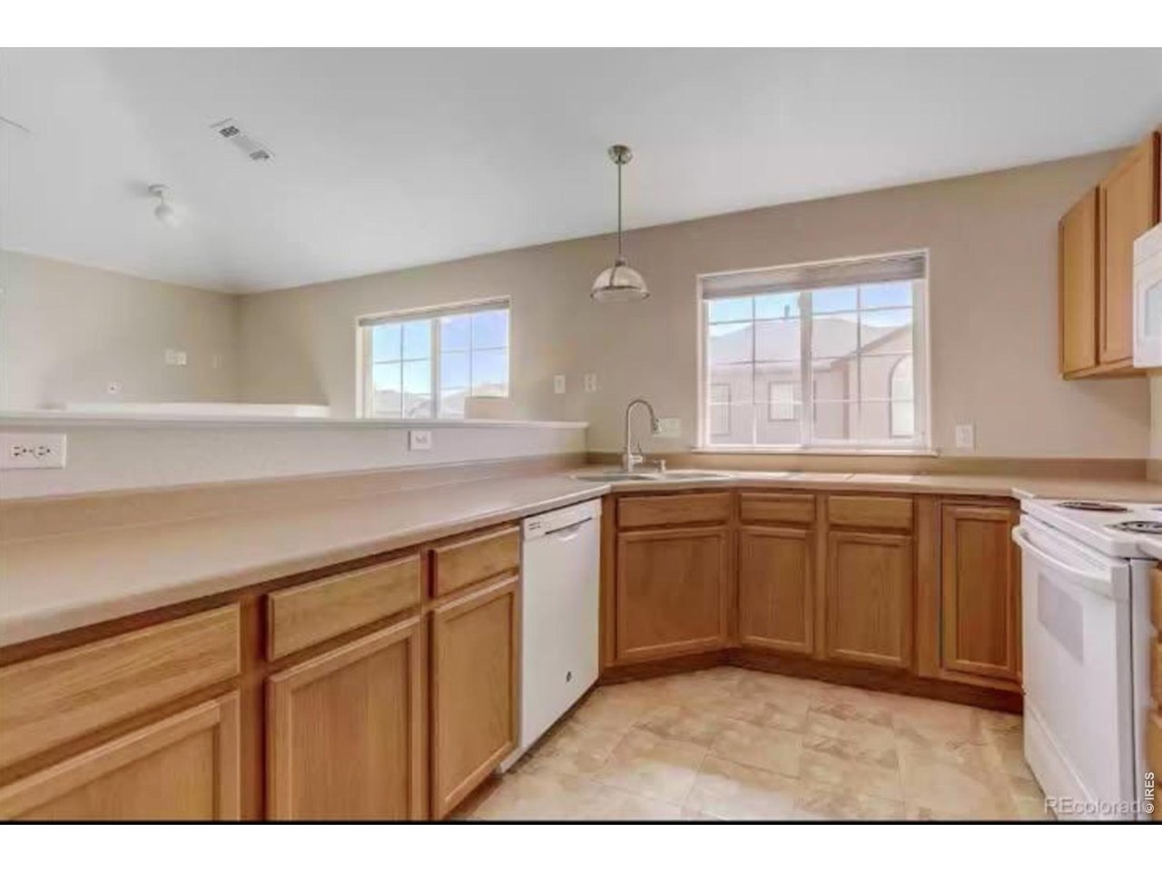 10381 Cook Way, Unit 206 Thornton, CO 80229 - Photo 5 of 39 Big kitchen with plenty of counter and cabinet space, corner stainless sink with amazing light from southern exposure.