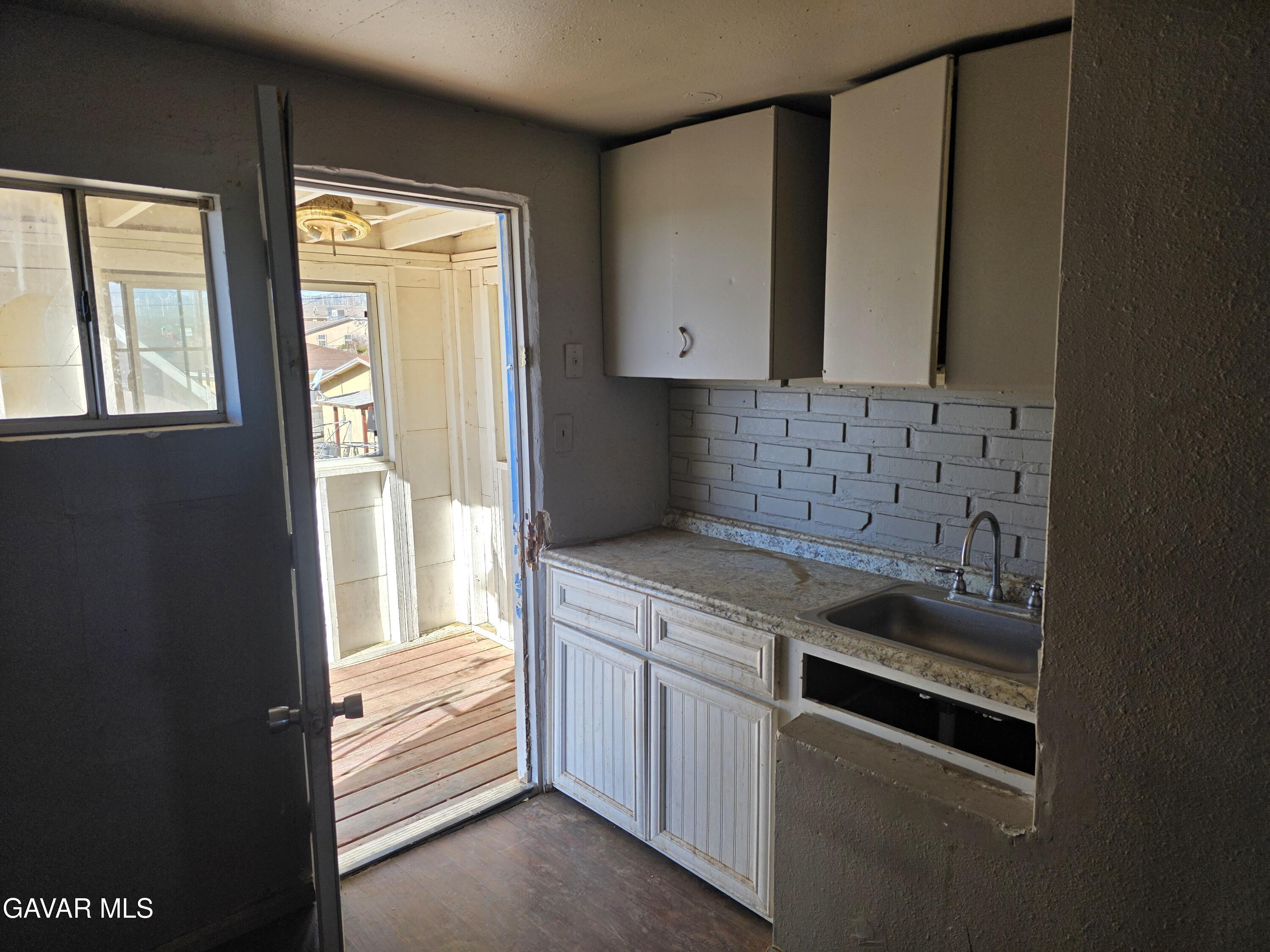 16133 I Street Mojave, CA 93501 - Photo 18 of 30 a kitchen with a stove and a cabinet