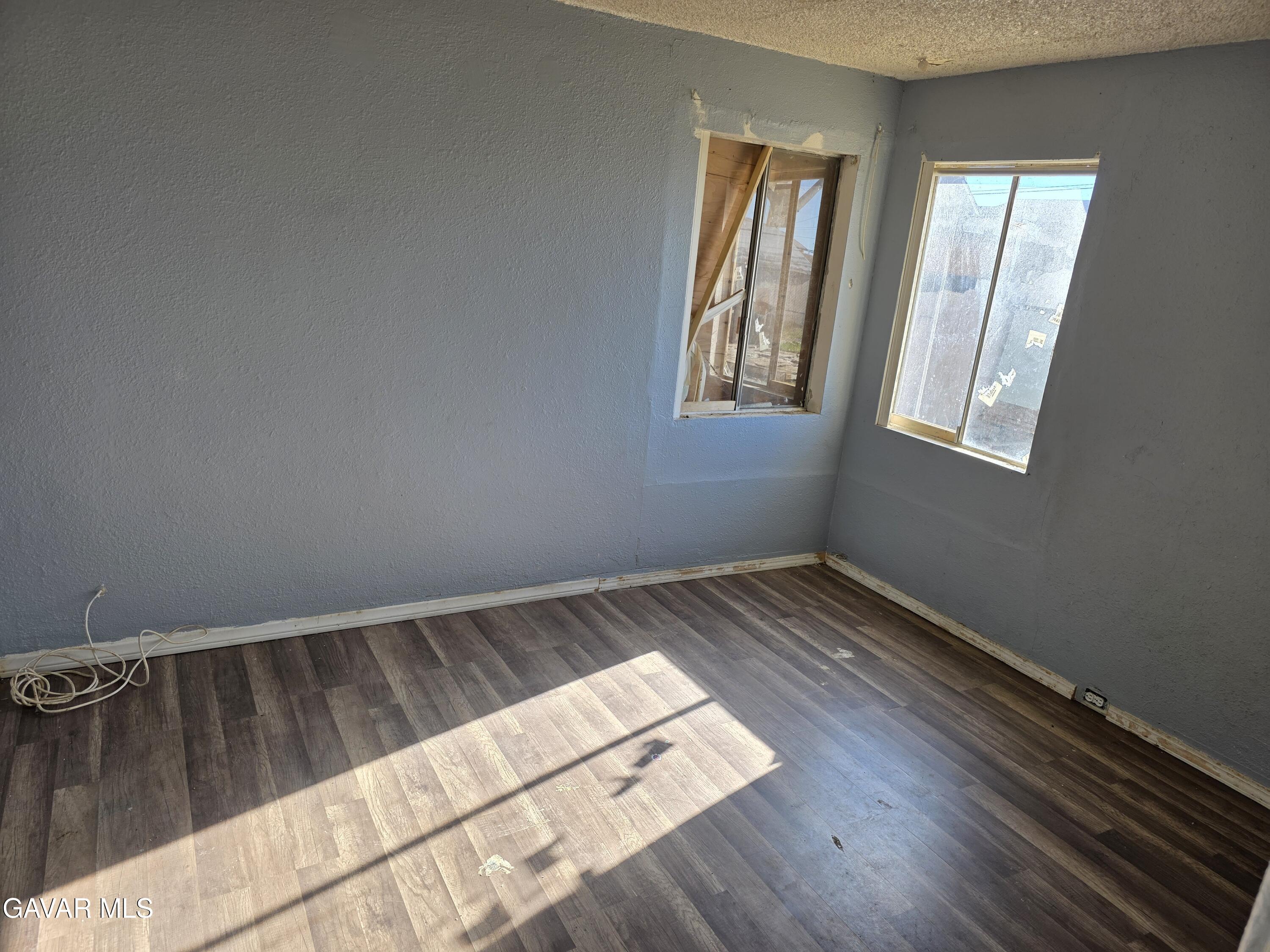 16133 I Street Mojave, CA 93501 - Photo 28 of 30 a view of wooden floor and windows in a room