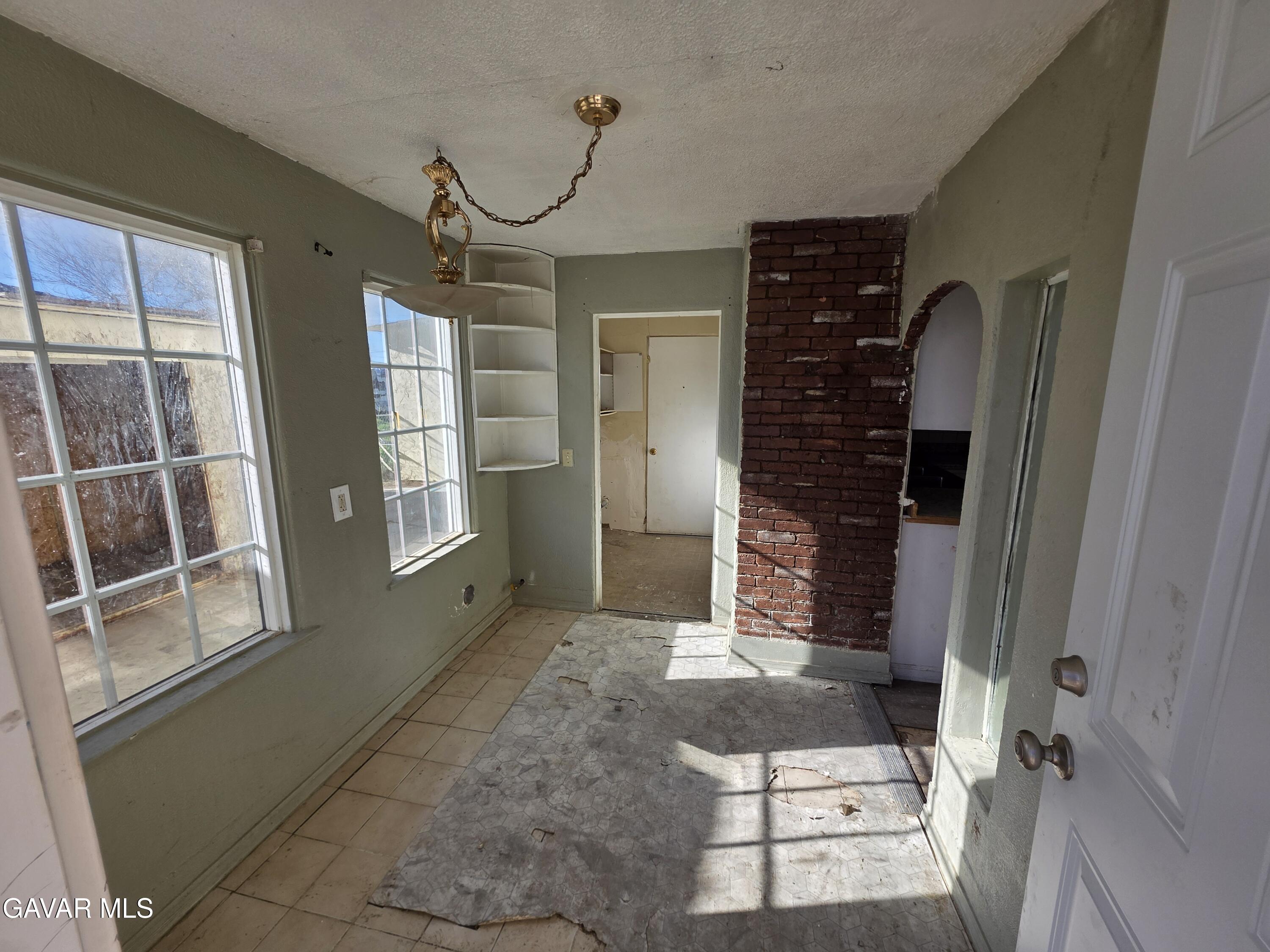 16133 I Street Mojave, CA 93501 - Photo 3 of 30 a living room with furniture a flat screen tv and a large window