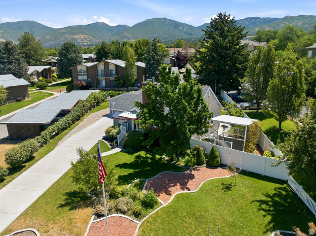 1925 South Main Street Bountiful, UT 84010 - Photo 41 of 48 Landscaped exterior featuring a prominent flagpole, a concrete driveway, and a white picket fence