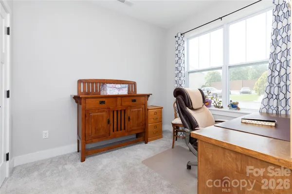 a view of workspace with furniture and window