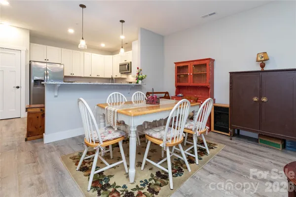 a view of a dining room with furniture and wooden floor