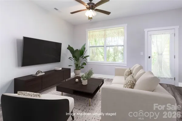a living room with furniture and a flat screen tv