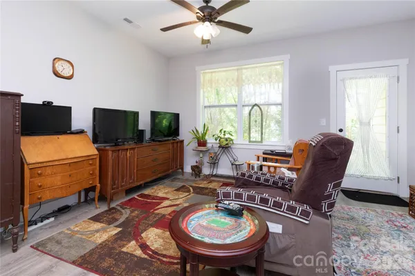 a living room with furniture and a flat screen tv