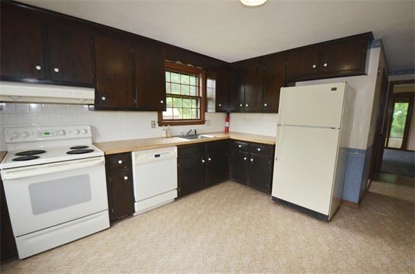 a kitchen with a cabinets and white appliances