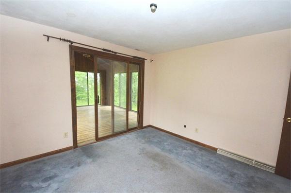 642 Wheeler Road Dracut, MA 01826 - Photo 11 of 30 a view of an empty room with a sliding door
