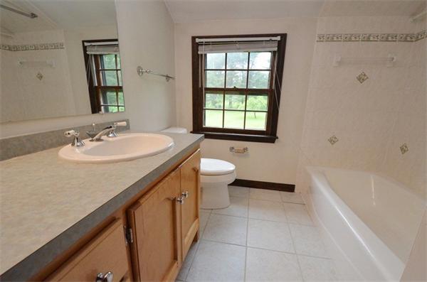 642 Wheeler Road Dracut, MA 01826 - Photo 17 of 30 a bathroom with a sink a toilet and shower