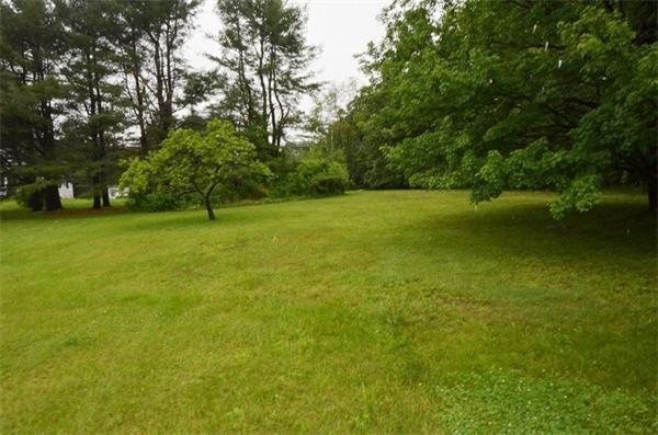 642 Wheeler Road Dracut, MA 01826 - Photo 30 of 30 a backyard of a house with lots of green space
