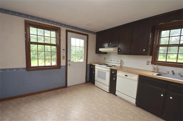 642 Wheeler Road Dracut, MA 01826 - Photo 3 of 30 a kitchen with a sink stove and cabinets