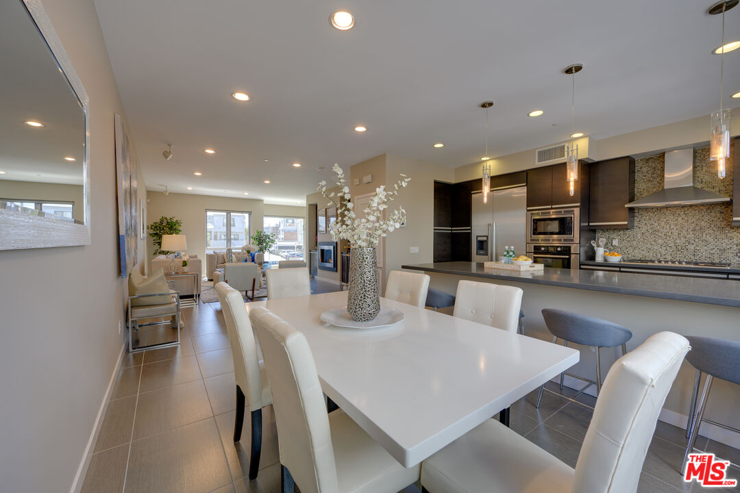 310 Washington Boulevard, Unit 802 Marina del Rey, CA 90292 - Photo 12 of 43 a large kitchen with kitchen island a dining table and chairs