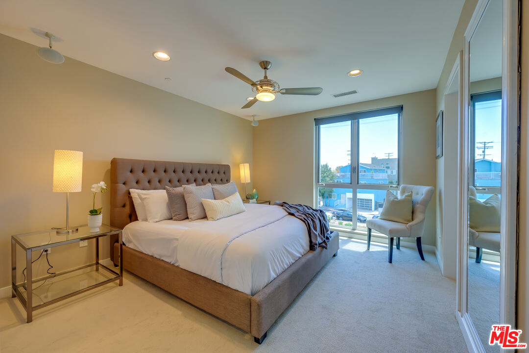 310 Washington Boulevard, Unit 802 Marina del Rey, CA 90292 - Photo 13 of 43 a bedroom with a bed a chandelier and window