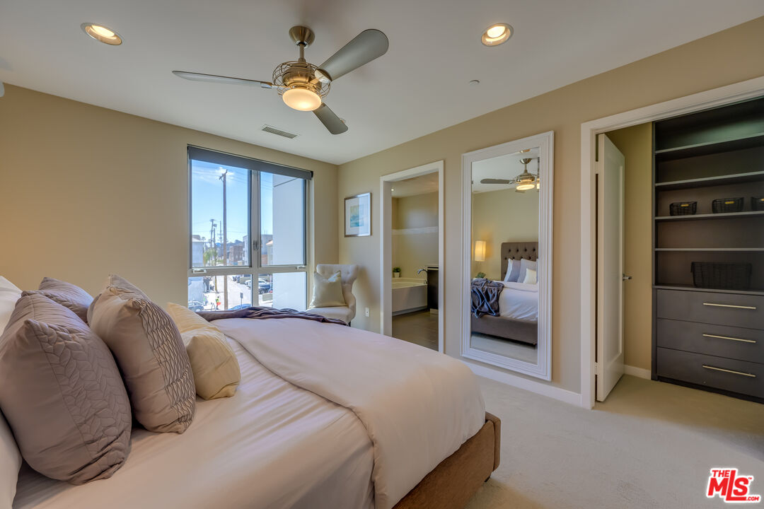 310 Washington Boulevard, Unit 802 Marina del Rey, CA 90292 - Photo 14 of 43 a bedroom with a bed and a chandelier