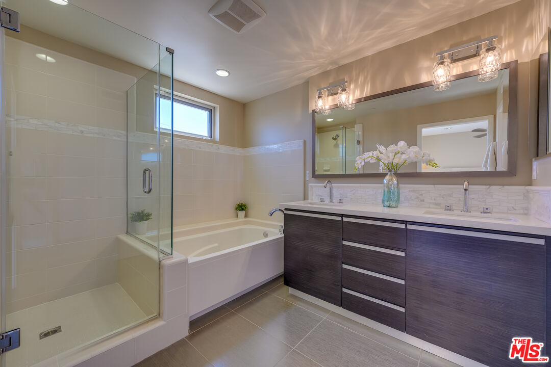 310 Washington Boulevard, Unit 802 Marina del Rey, CA 90292 - Photo 15 of 43 a bathroom with a bathtub sink and mirror