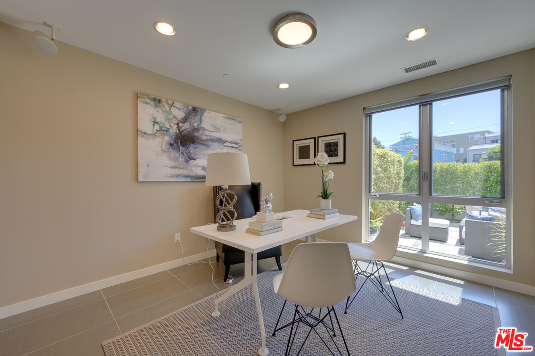 310 Washington Boulevard, Unit 802 Marina del Rey, CA 90292 - Photo 22 of 43 a view of a dining room with furniture large windows and wooden floor