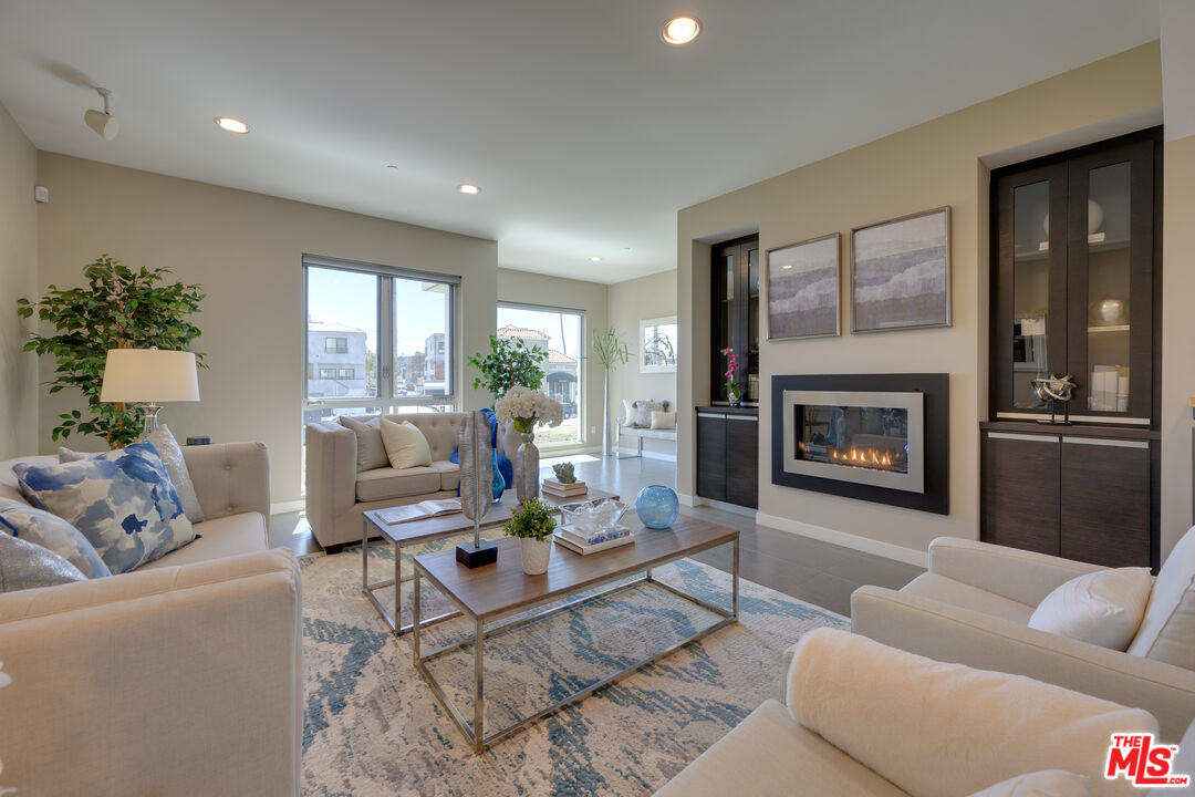 310 Washington Boulevard, Unit 802 Marina del Rey, CA 90292 - Photo 3 of 43 a living room with furniture fireplace and a large window
