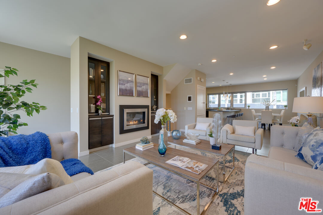 310 Washington Boulevard, Unit 802 Marina del Rey, CA 90292 - Photo 4 of 43 a living room with fireplace furniture and a large window
