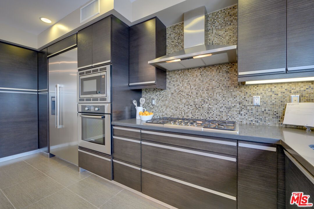 310 Washington Boulevard, Unit 802 Marina del Rey, CA 90292 - Photo 10 of 43 a kitchen with cabinets and stainless steel appliances