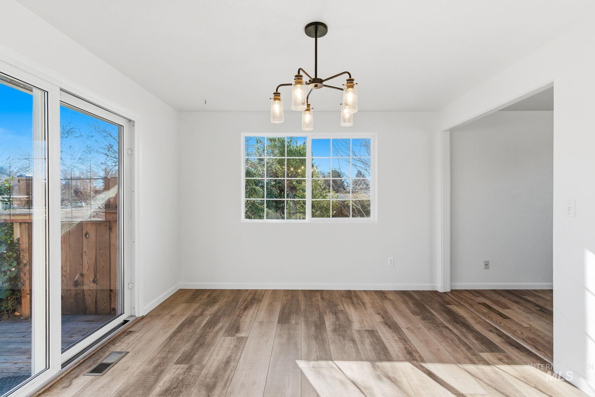 2072 South Crystal Way Boise, ID 83706 - Photo 12 of 50 Unfurnished dining area featuring a chandelier and light wood finished floors