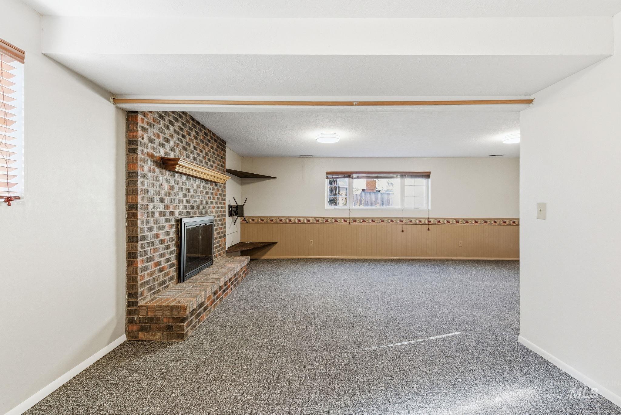 2072 South Crystal Way Boise, ID 83706 - Photo 29 of 50 Unfurnished living room featuring carpet flooring and a fireplace