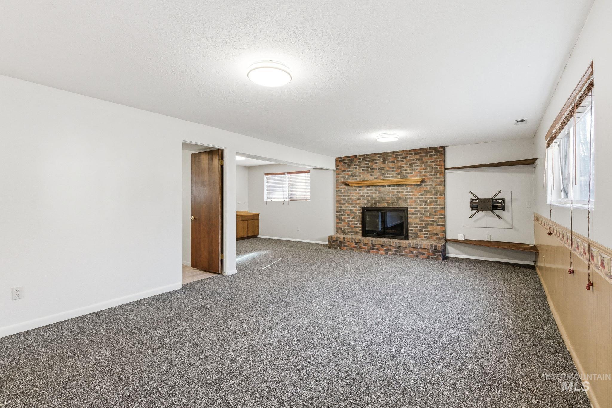2072 South Crystal Way Boise, ID 83706 - Photo 30 of 50 Unfurnished living room featuring a fireplace and carpet