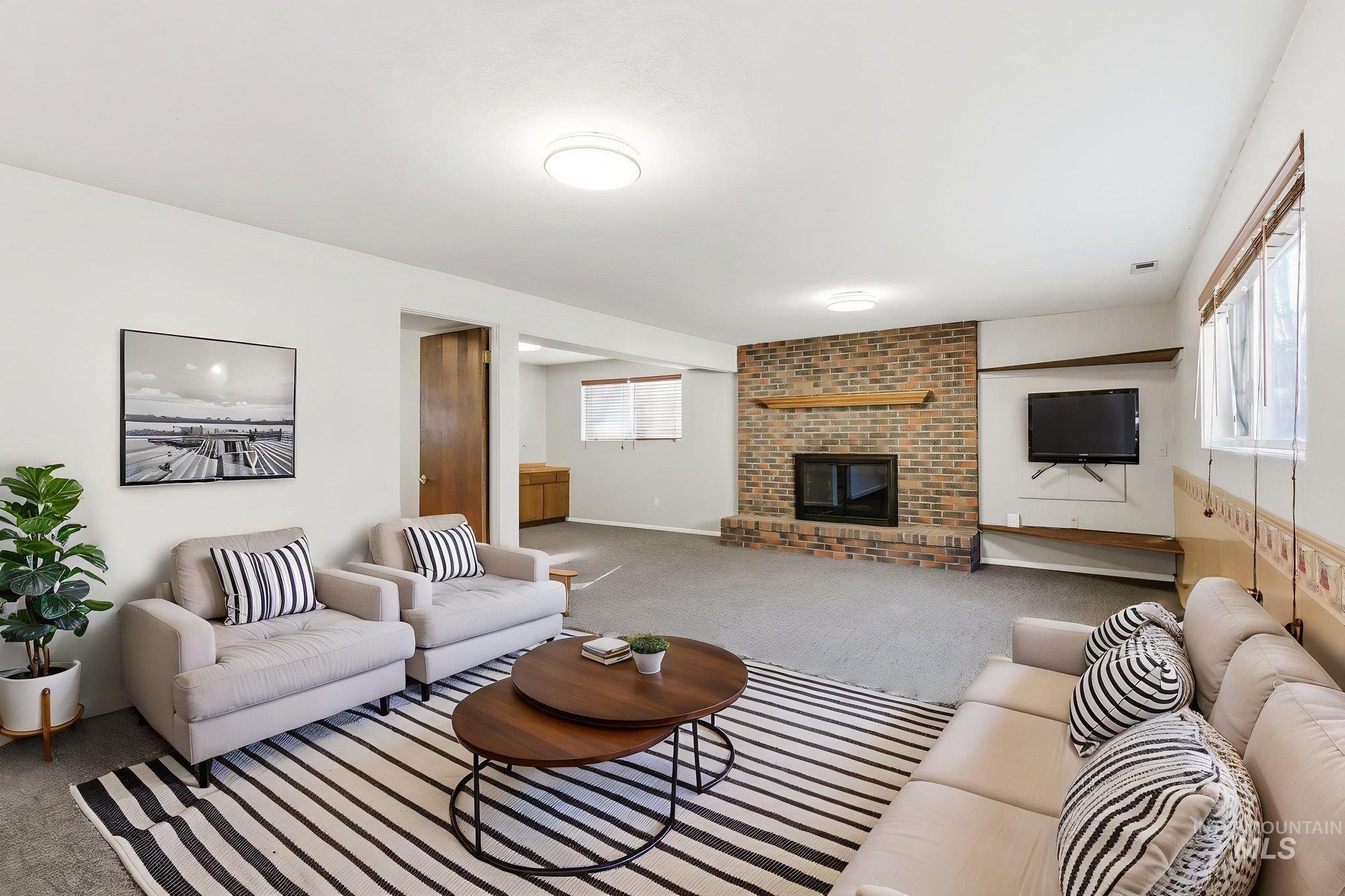2072 South Crystal Way Boise, ID 83706 - Photo 31 of 50 Living area with carpet floors and a brick fireplace